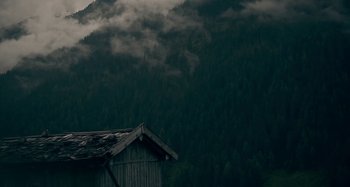 Movie still from “The Field Guide to Evil” (2018), directed by Can Evrenol – A wooden hut in the middle of a forest; Extreme Wide shot, Low angle