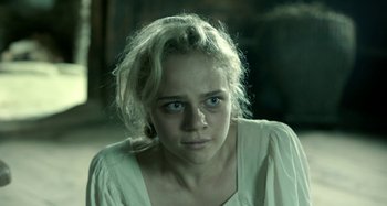 Movie still from “The Field Guide to Evil” (2018), directed by Can Evrenol – A woman with blue eyes stares into the camera; Close Up shot, High angle