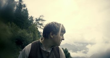 Movie still from “The Field Guide to Evil” (2018), directed by Can Evrenol – A young man is looking into the distance; Close Up shot, Low angle