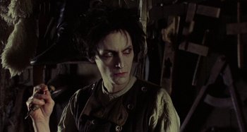 Movie still from “The Field Guide to Evil” (2018), directed by Can Evrenol – A person wearing a costume; Close Up shot, Over the shoulder angle