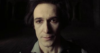 Movie still from “The Field Guide to Evil” (2018), directed by Can Evrenol – A person wearing a shirt; Close Up shot, High angle