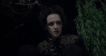 Movie still from “The Field Guide to Evil” (2018), directed by Can Evrenol – A person wearing a costume; Medium shot, Low angle