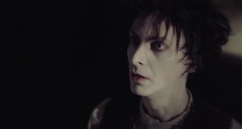 Movie still from “The Field Guide to Evil” (2018), directed by Can Evrenol – A person wearing a white shirt; Close Up shot, Over the shoulder angle