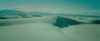 Movie still from “The First Purge” (2018), directed by Gerard McMurray – A view of a desert landscape with mountains in the background; Extreme Wide shot, High angle