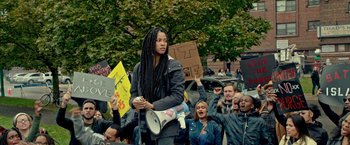 Movie still from “The First Purge” (2018), directed by Gerard McMurray – A group of people gathered in the street to protest; Medium shot, High angle
