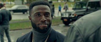 Movie still from “The First Purge” (2018), directed by Gerard McMurray – A person wearing a jacket; Close Up shot, Over the shoulder angle