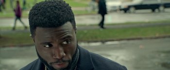 Movie still from “The First Purge” (2018), directed by Gerard McMurray – A person wearing a jacket; Close Up shot, Over the shoulder angle