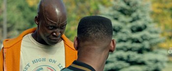 Movie still from “The First Purge” (2018), directed by Gerard McMurray – Two men talking to each other in front of a tree; Close Up shot, Over the shoulder angle