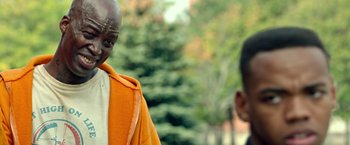 Movie still from “The First Purge” (2018), directed by Gerard McMurray – Two men standing next to each other in front of trees; Close Up shot, Over the shoulder angle