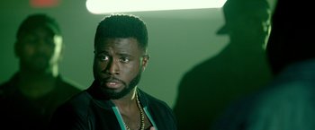 Movie still from “The First Purge” (2018), directed by Gerard McMurray – A person with a beard; Close Up shot, Over the shoulder angle