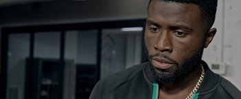 Movie still from “The First Purge” (2018), directed by Gerard McMurray – A person with a beard; Close Up shot, Over the shoulder angle