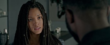 Movie still from “The First Purge” (2018), directed by Gerard McMurray – A young woman with long braids looking at a man; Close Up shot, Over the shoulder angle