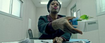 Movie still from “The First Purge” (2018), directed by Gerard McMurray – A person sitting at a table with a pen and paper; Close Up shot, Low angle