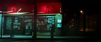 Movie still from “The First Purge” (2018), directed by Gerard McMurray – A fire hydrant in front of a store at night; Extreme Wide shot, High angle