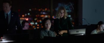 Movie still from “The First Purge” (2018), directed by Gerard McMurray – A man and a woman are looking at a computer screen; Medium shot, Low angle