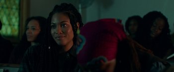 Movie still from “The First Purge” (2018), directed by Gerard McMurray – A person holding a pillow; Close Up shot, Over the shoulder angle