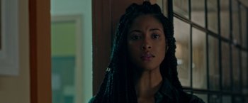 Movie still from “The First Purge” (2018), directed by Gerard McMurray – A person with long braids; Close Up shot, Over the shoulder angle