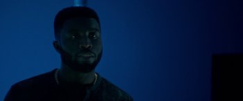 Movie still from “The First Purge” (2018), directed by Gerard McMurray – A person wearing a necklace; Close Up shot, Low angle