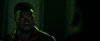 Movie still from “The First Purge” (2018), directed by Gerard McMurray – A person wearing a leather jacket; Close Up shot, Over the shoulder angle