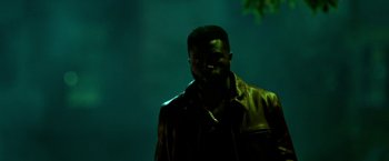 Movie still from “The First Purge” (2018), directed by Gerard McMurray – A man wearing a leather jacket standing in the dark; Medium shot, Low angle