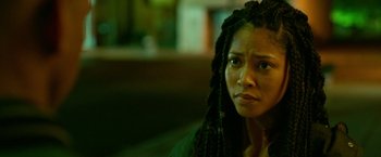 Movie still from “The First Purge” (2018), directed by Gerard McMurray – A person with dreadlocks looking at the camera; Close Up shot, Over the shoulder angle