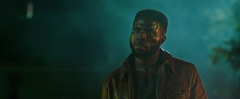 Movie still from “The First Purge” (2018), directed by Gerard McMurray – A man in a leather jacket looking up at the sky; Close Up shot, Low angle