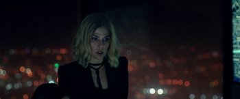 Movie still from “The First Purge” (2018), directed by Gerard McMurray – A woman in a black dress standing in front of lights; Close Up shot, Over the shoulder angle