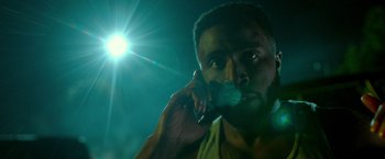 Movie still from “The First Purge” (2018), directed by Gerard McMurray – A person talking on a cell phone; Close Up shot, Low angle