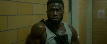 Movie still from “The First Purge” (2018), directed by Gerard McMurray – A person wearing a tank top; Close Up shot, Low angle