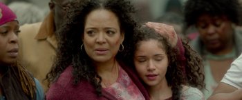 Movie still from “The First Purge” (2018), directed by Gerard McMurray – A woman and a girl are standing next to each other; Close Up shot, High angle