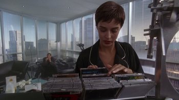 Movie still from “The Fisher King” (1991), directed by Terry Gilliam – A woman is looking at a bunch of cds; Medium shot, High angle