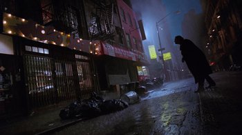 Movie still from “The Fisher King” (1991), directed by Terry Gilliam – A man walking down the street in the rain at night; Extreme Wide shot, Low angle