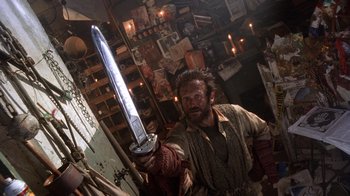 Movie still from “The Fisher King” (1991), directed by Terry Gilliam – A man holding a sword in a room filled with candles; Close Up shot, Low angle