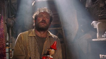 Movie still from “The Fisher King” (1991), directed by Terry Gilliam – A man holding a gnome in his hand; Close Up shot, Low angle