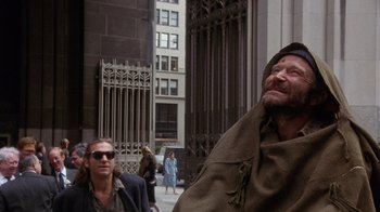 Movie still from “The Fisher King” (1991), directed by Terry Gilliam – A man with a long beard and a brown jacket; Medium shot, Over the shoulder angle