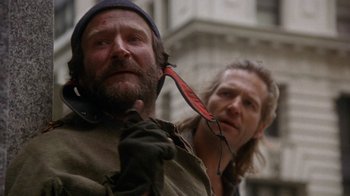 Movie still from “The Fisher King” (1991), directed by Terry Gilliam – A man with a beard and a hat on and another man with a beard and a hat on; Close Up shot, Low angle