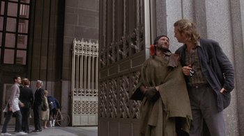 Movie still from “The Fisher King” (1991), directed by Terry Gilliam – A man and a woman standing next to each other outside; Wide shot, Over the shoulder angle