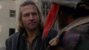 Movie still from “The Fisher King” (1991), directed by Terry Gilliam – A man standing next to another man holding a bloody knife; Close Up shot, Over the shoulder angle
