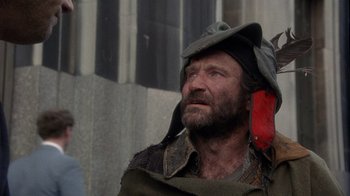 Movie still from “The Fisher King” (1991), directed by Terry Gilliam – A man with a beard and a hat is looking up; Close Up shot, Low angle