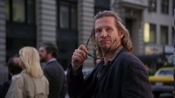 Movie still from “The Fisher King” (1991), directed by Terry Gilliam – A man with long hair holding a pair of eyeglasses; Close Up shot, Low angle