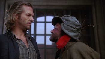 Movie still from “The Fisher King” (1991), directed by Terry Gilliam – Two men standing next to each other in front of a building; Medium shot, Over the shoulder angle