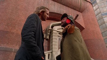 Movie still from “The Fisher King” (1991), directed by Terry Gilliam – Two men talking to each other in front of a brick building; Medium shot, Over the shoulder angle