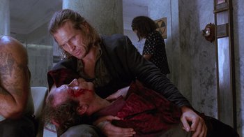 Movie still from “The Fisher King” (1991), directed by Terry Gilliam – A man in a black jacket and a woman in a red dress; Medium shot, Over the shoulder angle