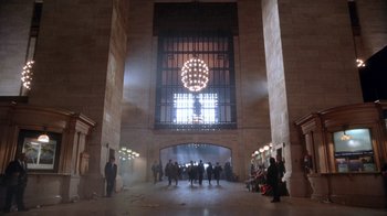 Movie still from “The Fisher King” (1991), directed by Terry Gilliam – A group of people standing inside of a large building; Extreme Wide shot, Low angle