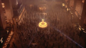 Movie still from “The Fisher King” (1991), directed by Terry Gilliam – A crowd of people standing around a lit candle in a building; Extreme Wide shot, Overhead angle
