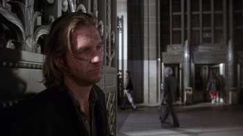 Movie still from “The Fisher King” (1991), directed by Terry Gilliam – A person standing in front of a building; Close Up shot, Over the shoulder angle