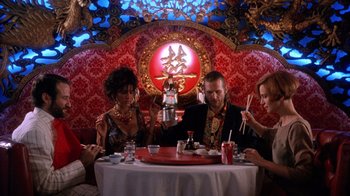 Movie still from “The Fisher King” (1991), directed by Terry Gilliam – A group of people sitting at a table with chopsticks; Wide shot, Low angle