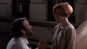 Movie still from “The Fisher King” (1991), directed by Terry Gilliam – A man and a woman standing next to each other; Close Up shot, Low angle