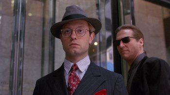 Movie still from “The Fisher King” (1991), directed by Terry Gilliam – A man in a suit and tie wearing a hat and sunglasses; Close Up shot, Low angle