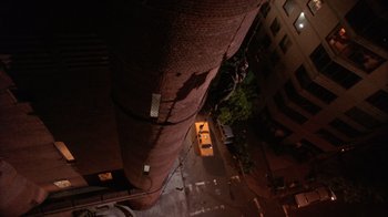 Movie still from “The Fisher King” (1991), directed by Terry Gilliam – Looking down at a city street at night time; Extreme Wide shot, Overhead angle